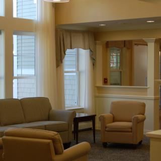 A cozy living room with comfortable seating and large windows.