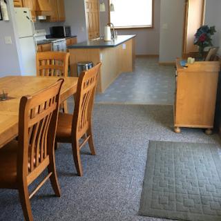 A cozy home interior featuring a dining table and kitchen.