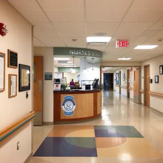 A view of the hospital reception area with a hallway leading to patient rooms.
