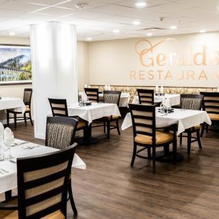 An elegant restaurant dining area with neatly arranged tables and chairs.