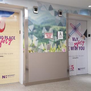 Colorful bathroom signage in a public space, featuring playful graphics and messages.