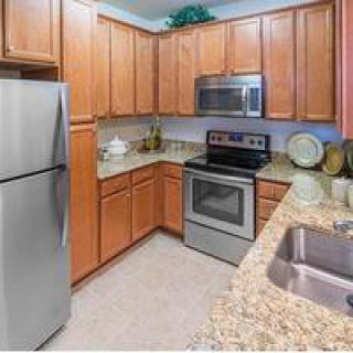 A modern kitchen with wooden cabinets and stainless steel appliances.