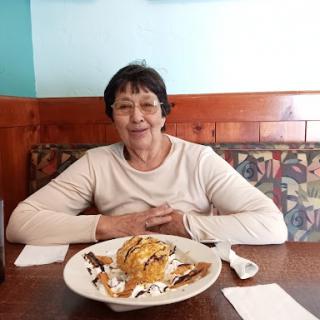 A woman enjoying a delicious dessert at a restaurant.