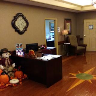 A cozy office waiting area decorated for autumn with pumpkins and a friendly atmosphere.