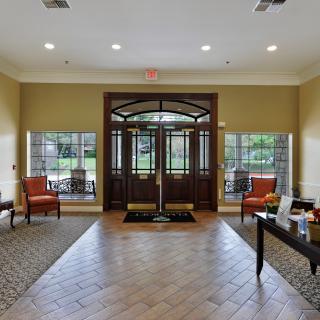 A spacious and inviting lobby entrance with large windows and comfortable seating.