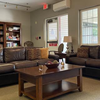 A cozy living room setup featuring comfortable sofas, a stylish coffee table, and warm lighting.