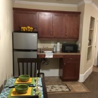 A cozy kitchen and dining area with a compact setup and vibrant table decor.
