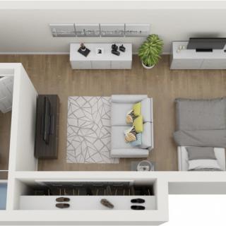 Aerial view of a modern apartment layout featuring a living area and bedroom.