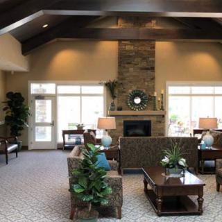 A cozy living room with elegant furniture and a stone fireplace, creating a warm and inviting atmosphere.