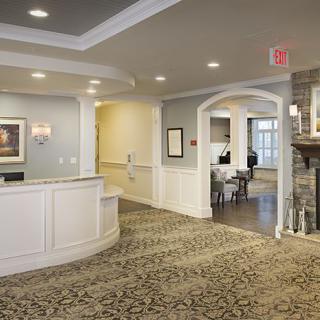A welcoming reception area with a spacious layout and cozy fireplace.