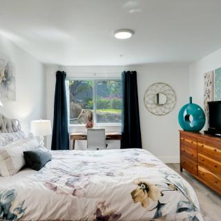 A well-decorated bedroom with a double bed, window, and modern furnishings.