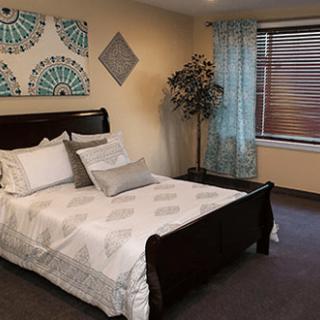 A modern bedroom with elegant furnishings and decor.