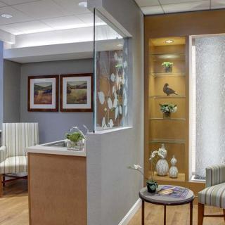 A modern waiting room with comfortable seating and decorative elements.