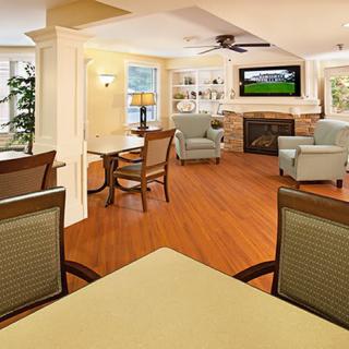 A cozy living room with comfortable seating, a fireplace, and a television.