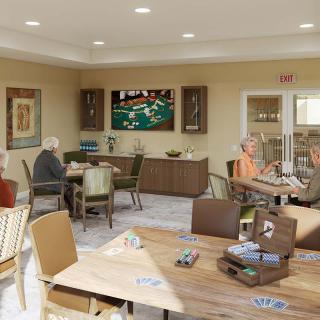 A group of seniors enjoying activities in a recreation room.