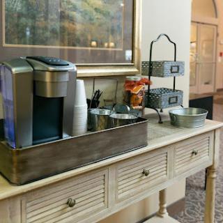 A cozy coffee station equipped with a beverage dispenser and various snacks, adding charm to the interior space.