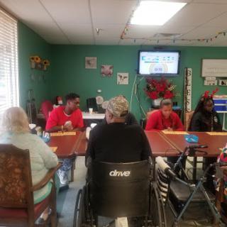 A lively gathering at a community center where elderly individuals engage in social activities.