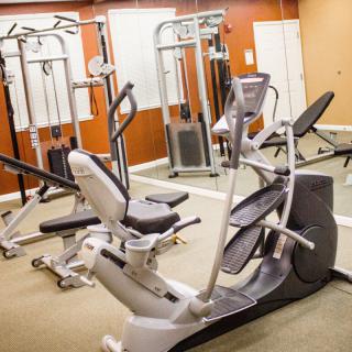 A gym room equipped with exercise machines and fitness equipment.