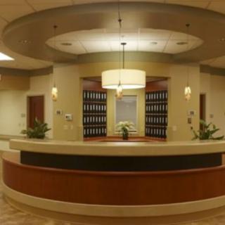 A modern reception desk with elegant lighting and decor in a lobby setting.