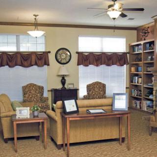 A cozy living room with comfortable seating, a bookshelf, and elegant decor.