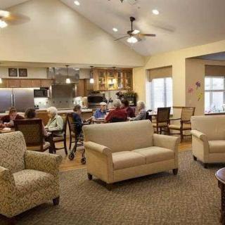 A cozy community living space with comfortable seating and a dining area.