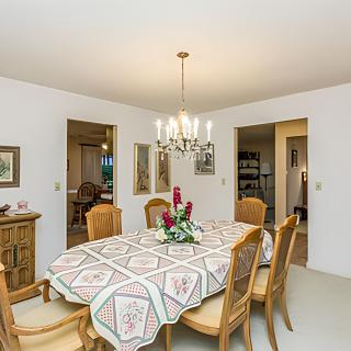 A classic dining room with a decorated table and chandelier.