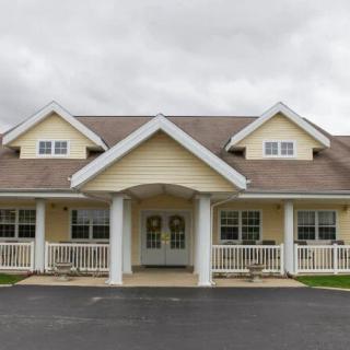 A suburban residential house with a porch and multiple gables.