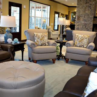 A cozy living room with comfortable armchairs and a sofa, complemented by decor items and warm lighting.