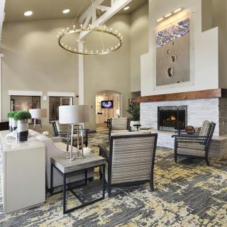 A modern lobby featuring comfortable seating and a stylish fireplace.