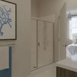 A modern bathroom interior with wall art and a neatly arranged sink area.