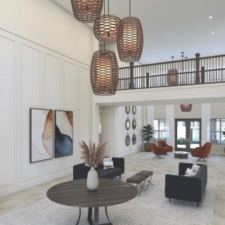 A modern lobby with stylish furniture and pendant lighting.