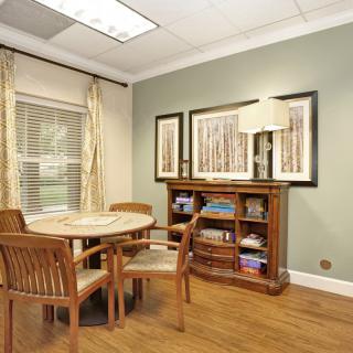 A cozy dining area with wooden furniture and decorative artwork.