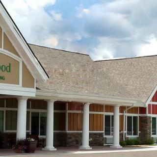 A storefront with a gabled roof and columned entrance.