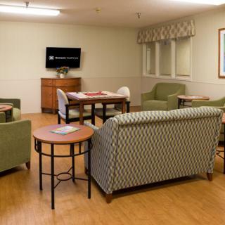 A cozy living room with comfortable seating arrangements and a television.