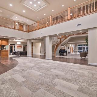 A luxurious and spacious interior with modern design, featuring an elegant staircase and open layout.