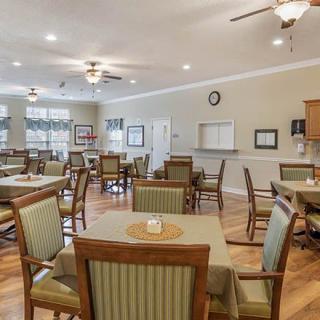 A well-organized dining room with multiple tables and chairs, designed for a community or senior living environment.