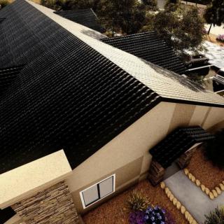 Aerial view of a house with solar panels installed on the roof.