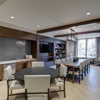 A modern open-concept living and dining area with contemporary furniture and ample natural light.