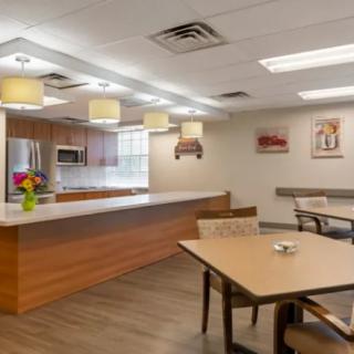 A modern kitchen and dining area with wooden furniture and bright lighting.