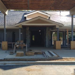 Under-construction building entrance with visible materials and scaffolding.