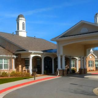 A modern building with a covered entrance and brick exterior.