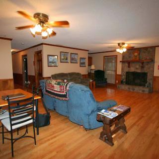 A cozy living room featuring comfortable seating, a fireplace, and a dining area.