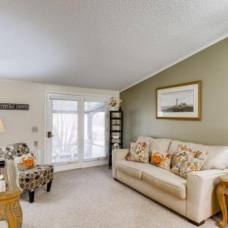 A cozy living room featuring a sofa, accent chair, and stylish decor.