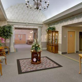 A well-decorated lobby with elegant furniture and greenery.