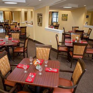 An inviting dining area with neatly arranged tables and chairs, featuring a cozy ambiance.