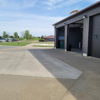 A spacious garage area with a clear sky in the background.
