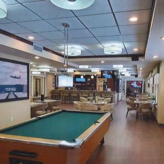 A well-furnished recreation room featuring a pool table and cozy seating arrangement.