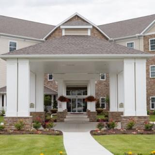 Entrance of a modern building with a landscaped walkway.