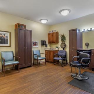 A cozy hair salon interior with mirrors, chairs, and a waiting area.