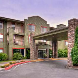 A modern hotel entrance with a covered driveway.